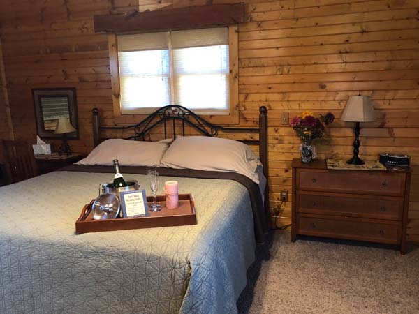 king size bed in rustic cabin